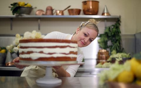 Claire Ptak puts the finishing touches to Prince Harry and Meghan Markle's cake - Credit:  Hannah McKay