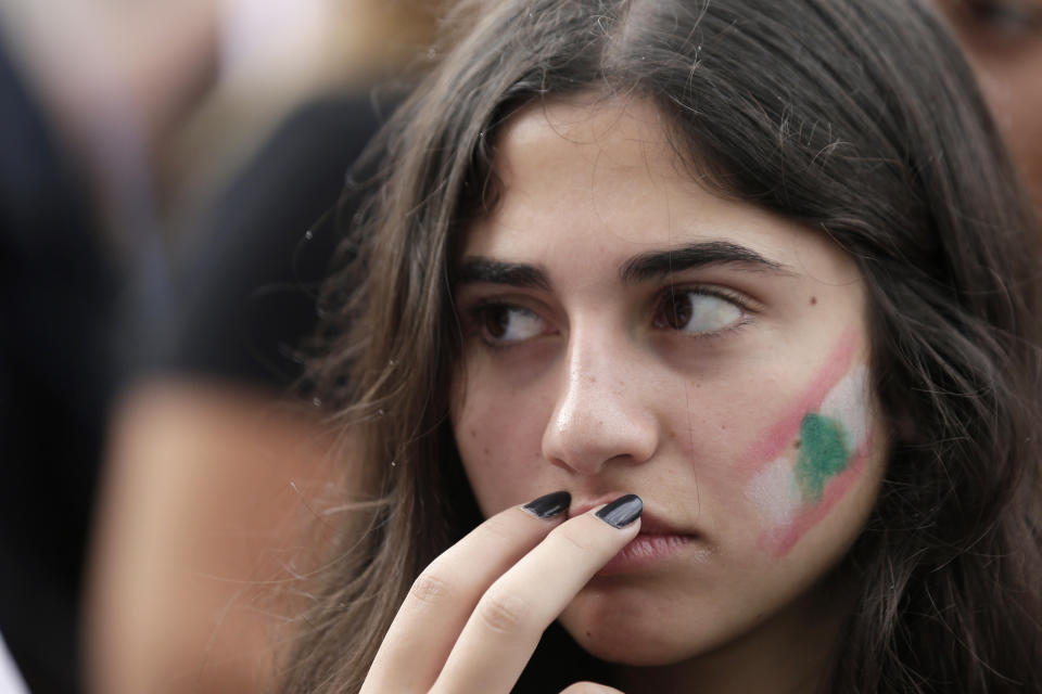 An anti-government protester reacts while listening to Lebanon's President Michel Aoun address the nation during a protest in the town of Jal el-Dib north of Beirut, Lebanon, Thursday, Oct. 24, 2019. Lebanon's President Michel Aoun has told tens of thousands of protesters that an economic reform package put forth by the country's prime minister will be the "first step" toward saving Lebanon from economic collapse. (AP Photo/Hassan Ammar)