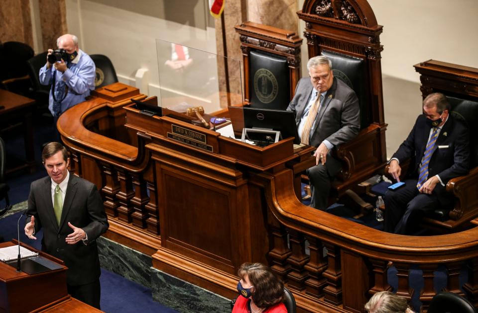 Gov. Andy Beshear speaks during his 2022 State Budget Address  at the state Capitol. Beshear says his proposal is Kentucky's chance "not just to tread water, but to lead." Behind Beshear are Senate President Robert Stivers and House Speaker David Osborne. Jan. 13, 2022