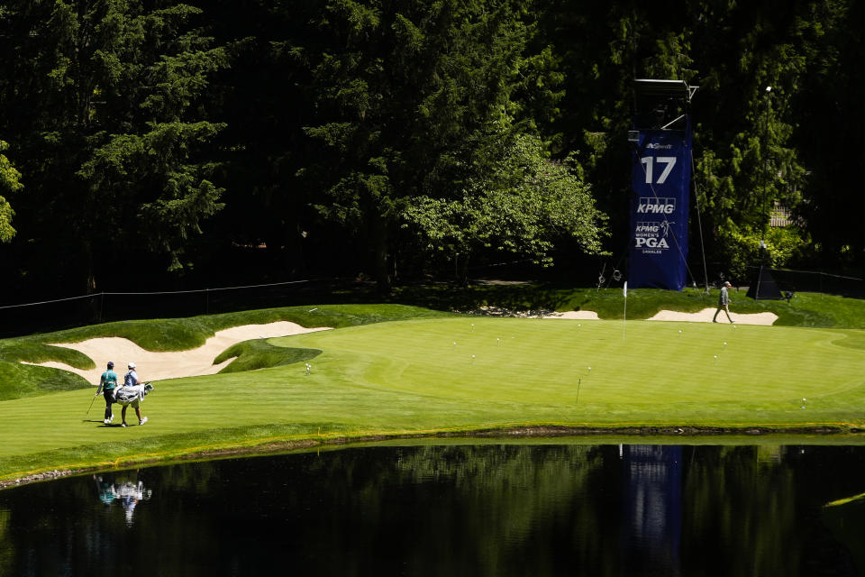 Yuka Saso, of Japan, walks with her caddie to the green of the 17th hole during a practice round for the Women's PGA Championship golf tournament at Sahalee Country Club, Wednesday, June 19, 2024, in Sammamish, Wash. (AP Photo/Lindsey Wasson)