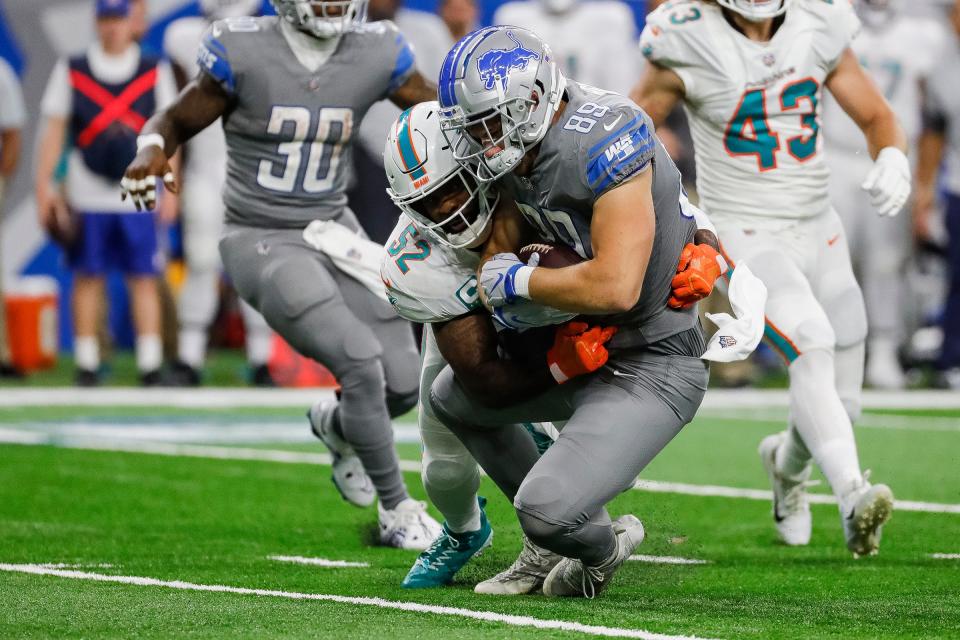 Detroit Lions tight end Brock Wright (89) is tackled by Miami Dolphins linebacker Elandon Roberts (52) during the second half at Ford Field in Detroit on Sunday, Oct. 30, 2022.