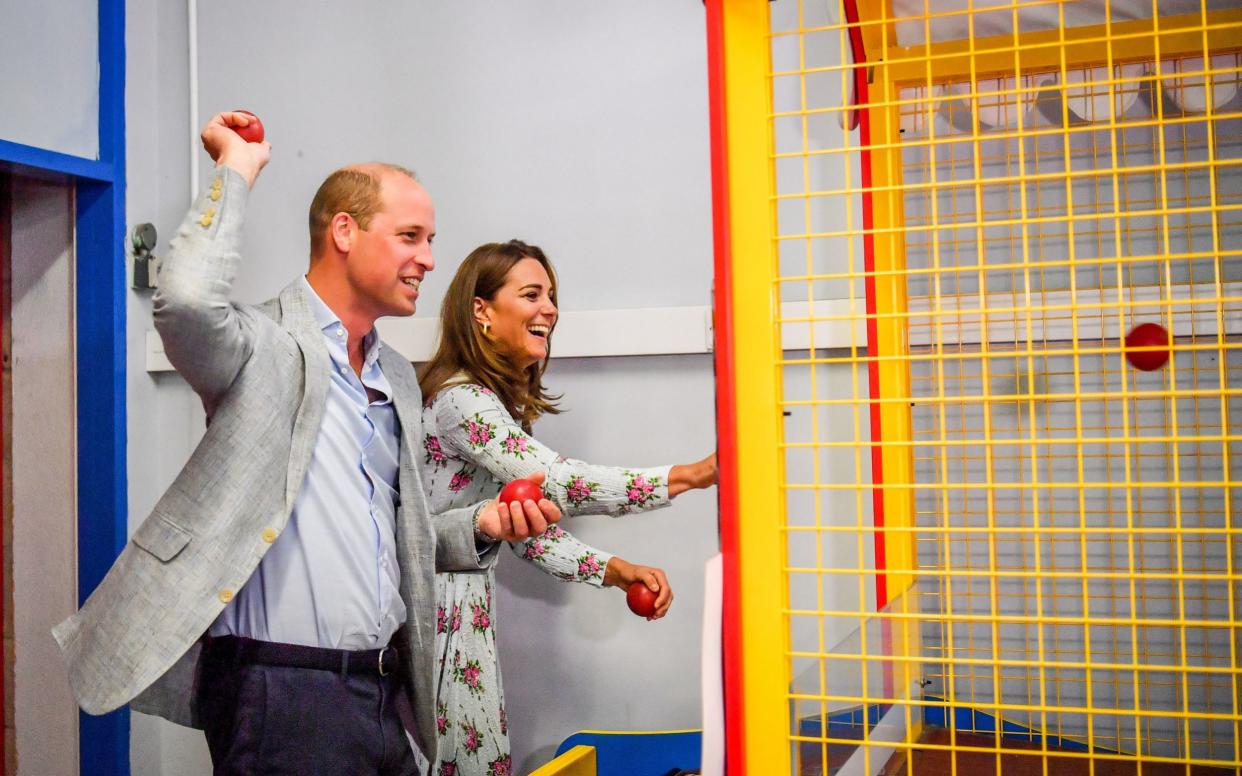 The Duke and Duchess of Cambridge throw balls on an arcade game in Barry Island, South Wales - Ben Birchall/PA