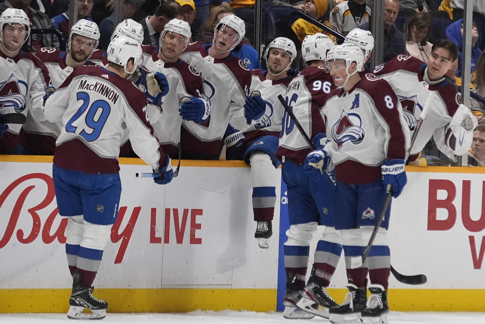 Colorado Avalanche center Nathan MacKinnon (29) celebrates his goal against the Nashville Predators with teammates during the first period of an NHL hockey game Saturday, March 2, 2024, in Nashville, Tenn. (AP Photo/George Walker IV)