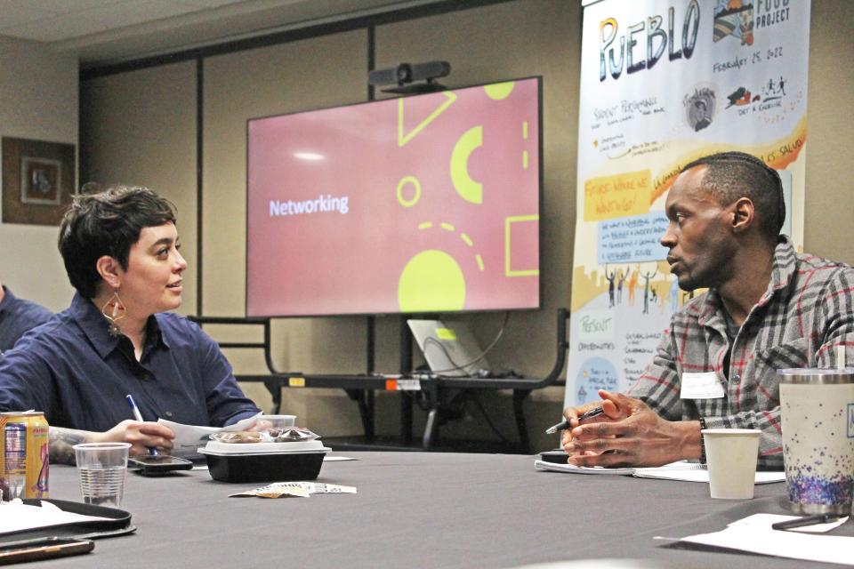 Dynelle Abeyta-Maestas speaks with Sam Umoh, general manager of the Hungry Buffalo, during a pitch competition at Pueblo Food Project's Sun Soil Water Ag Summit on Friday, Feb. 23, 2024.
