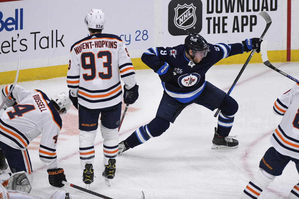 Winnipeg Jets' Andrew Copp (9) celebrates his goal against the Edmonton Oilers during the first period of an NHL hockey game Tuesday, Jan. 26, 2021, in Winnipeg, Manitoba. (Fred Greenslade/The Canadian Press via AP)