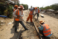 Railroad maintenance workers fix tracks outside Phnom Penh, Cambodia, Monday, April 22, 2019. The Cambodian-Thailand cross-border line has been not used for more than four decades due to Cambodia's civil war. In recent years the railroad has been renovated and both countries are looking to re-establish the rail link by the end of the year, local media say. (AP Photo/Heng Sinith)