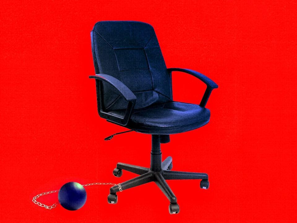 An office chair with a ball and chain attached to it.