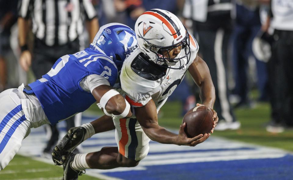 Virginia's Perris Jones, right, dives past Duke's Jaylen Stinson for a touchdown during the first half of an NCAA college football game in Durham, N.C., Saturday, Oct. 1, 2022. (AP Photo/Ben McKeown)