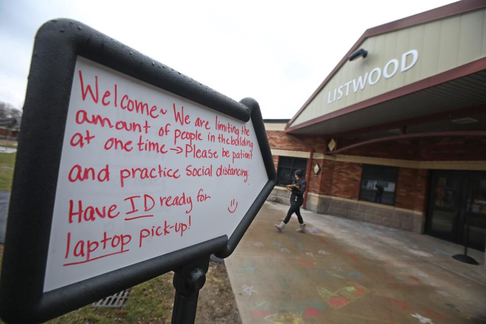 A sign points the way for a laptop pick-up at Listwood Elementary School in Irondequoit, New York.