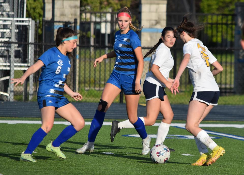 Players from Gibraltar Carlson and Airport converge on the ball during a District game at Carlson Wednesday.