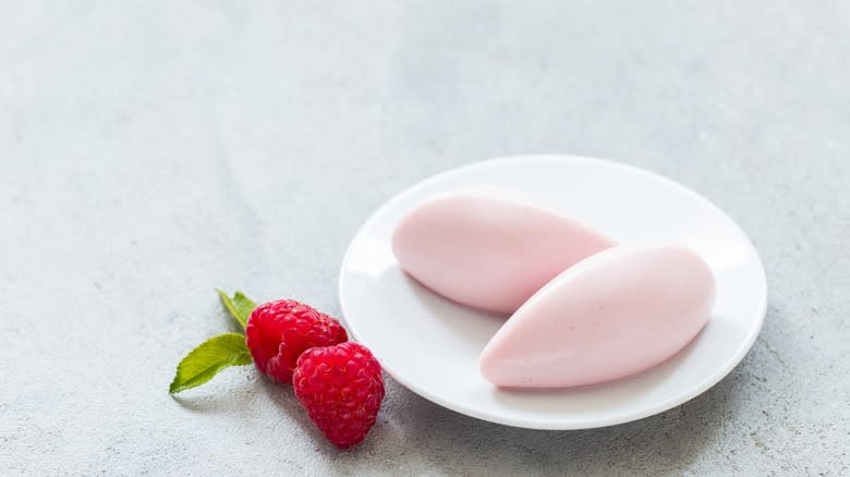 two raspberry cream quenelles