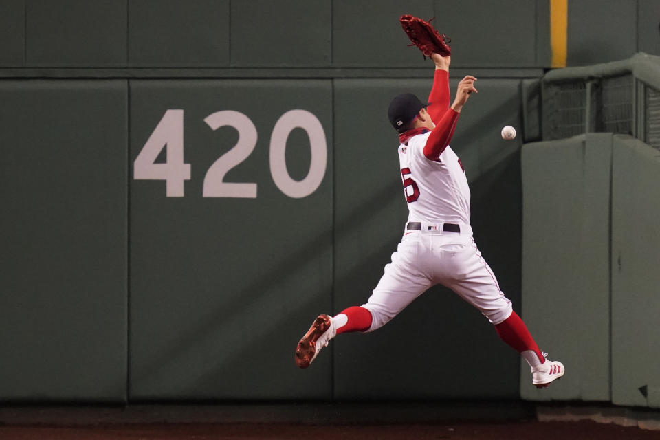 Boston Red Sox center fielder Enrique Hernandez leaps but can't make the play on an RBI double by Detroit Tigers' Robbie Grossman during the fifth inning of a baseball game at Fenway Park, Tuesday, May 4, 2021, in Boston. (AP Photo/Charles Krupa)