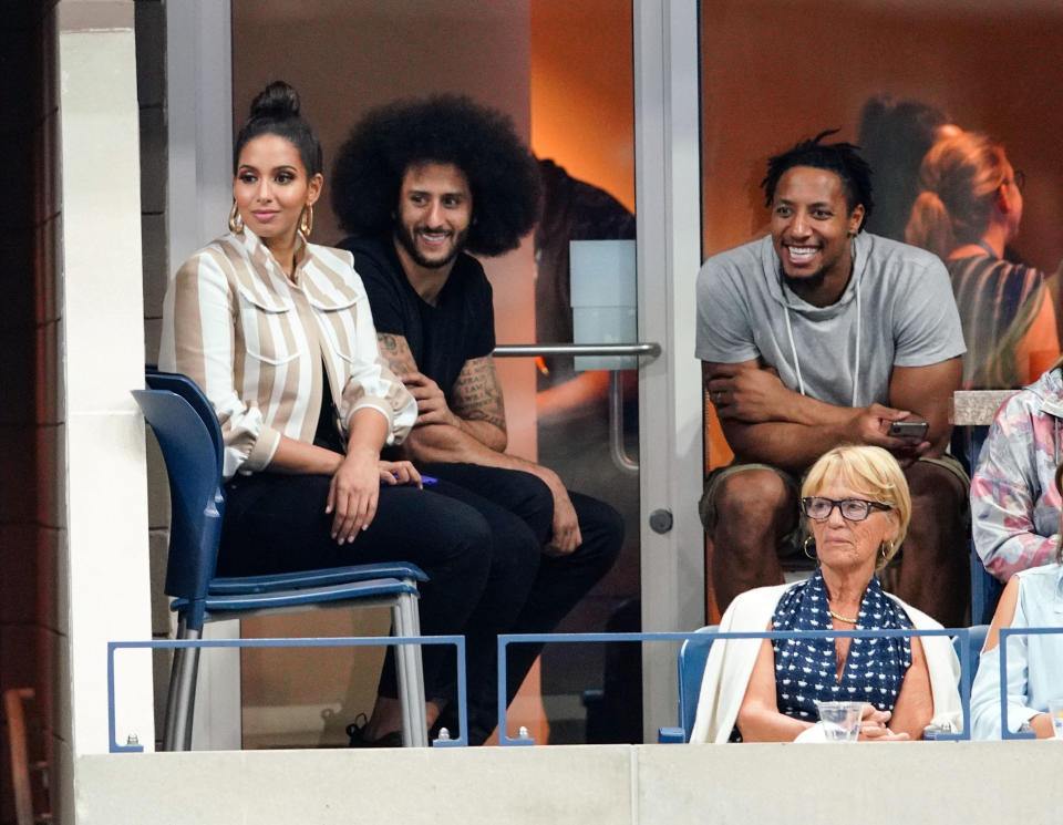 Colin Kaepernick, center, thanked his friend and former teammate, Carolina Panthers safety Eric Reid, right, for his support. (Getty Images)