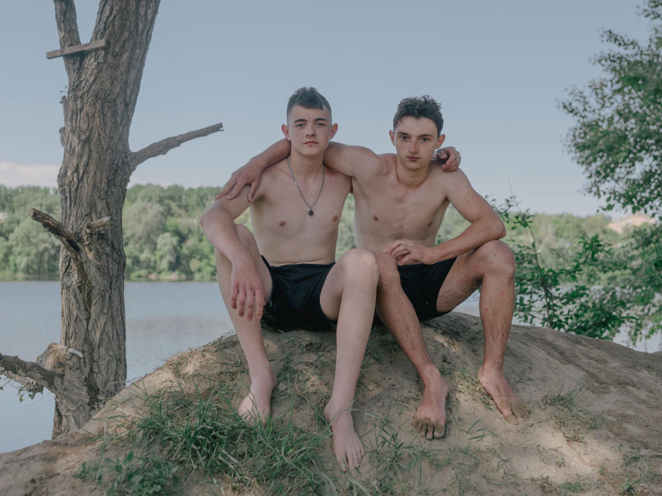 Close friends Grisha and Borys pose for a portrait at a lake. Within hours of leaving his home in Irpin, Grisha's street was taken over by Russian soldiers.<span class="copyright">Fabian Ritter—DOCKS Collective</span>