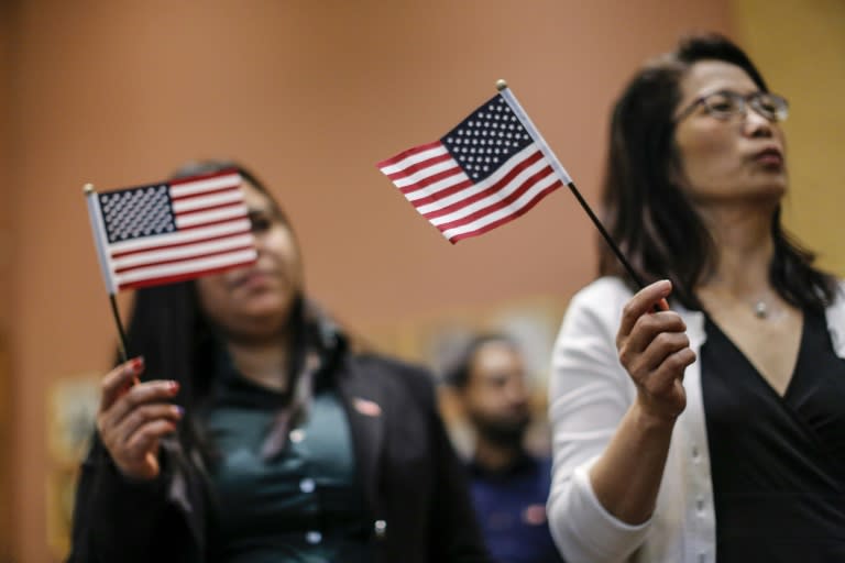 Candidates for US citizenship take the oath of allegiance during a Naturalization Ceremony for new US citizens at the City Hall of Jersey City in New Jersey on February 22, 2017