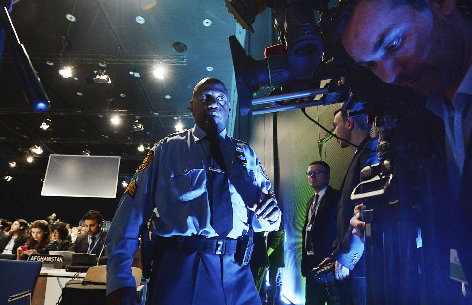 U.N. uniformed guards watch over the participants in a climate conference in Katowice,Poland, Tuesday, Dec. 11, 2018. (AP Photo/Czarek Sokolowski)