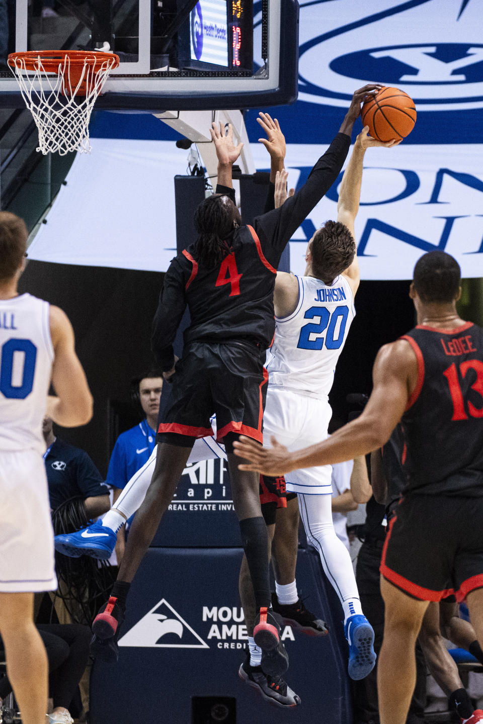 San Diego State forward Jay Pal (4) blocks a shot from BYU guard Spencer Johnson (20) during the first half of an NCAA college basketball game Friday, Nov. 10, 2023, in Provo, Utah. (AP Photo/Isaac Hale)