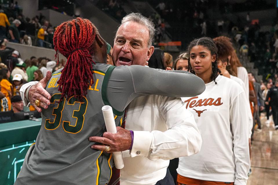 Texas coach Vic Schaefer hugs Baylor guard Aiiha Blackwell after Thursday night's game. With the Longhorns headed to the SEC, there's no guarantee of future Texas-Baylor games. Schaefer was noncommittal. "If it fits on the schedule, I certainly don't have a problem playing it," he said.