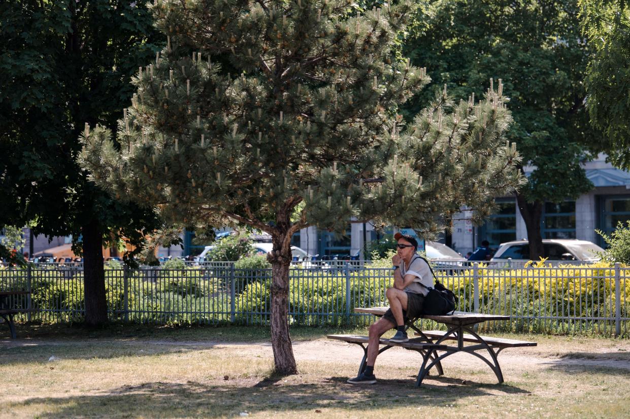 A man seeks out some shade during a recent heatwave in Montreal