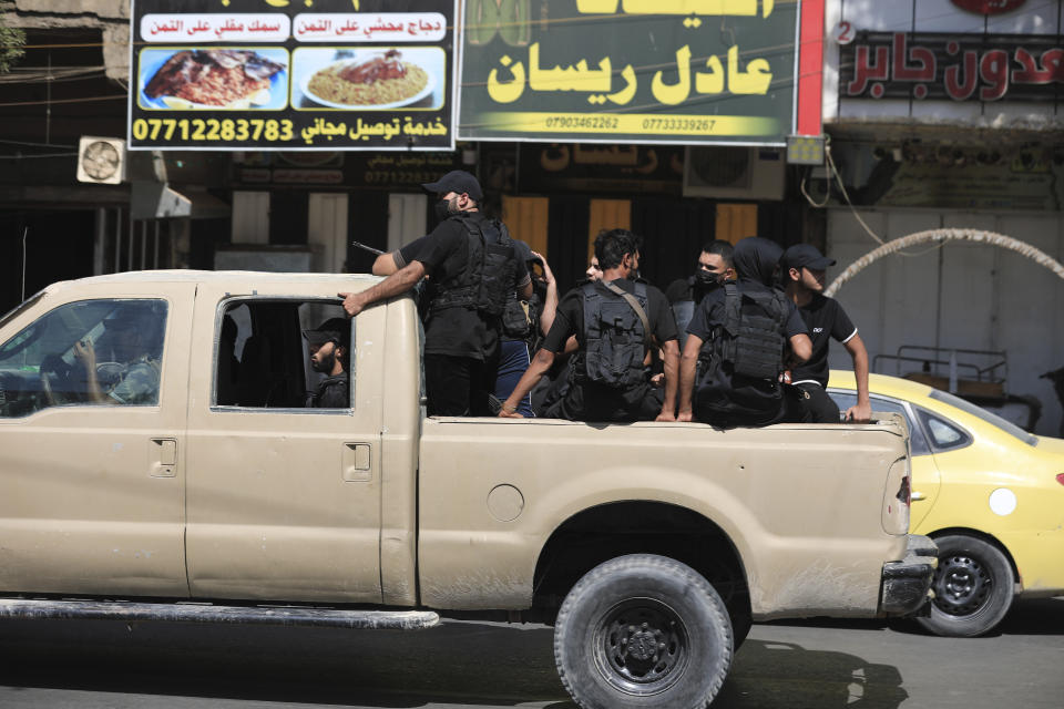 Fighters from the Saraya Salam (Peace Brigades) loyal to influential Iraqi cleric Muqtada al-Sadr deploy in Baghdad, Iraq, Tuesday, Aug. 30, 2022. Al-Sadr has called on his supporters to withdraw from the capital's government quarter. His supporters have traded heavy fire with security forces there in a serious escalation of a months-long political crisis gripping the nation. (AP Photo/Murtadha Ridha)