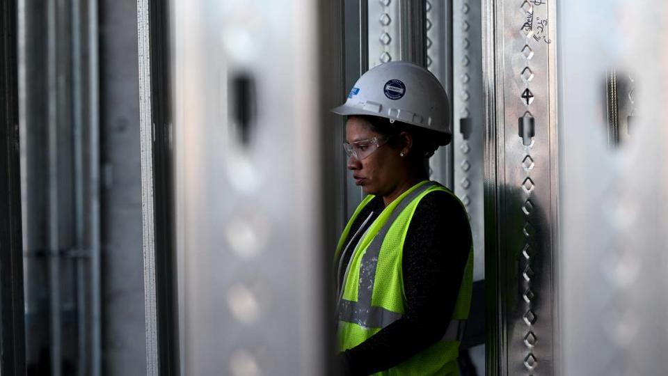 A worker is seen through metal framing in the interior of Mote SEA during a media tour of the ongoing construction on Friday, April 5, 2024.