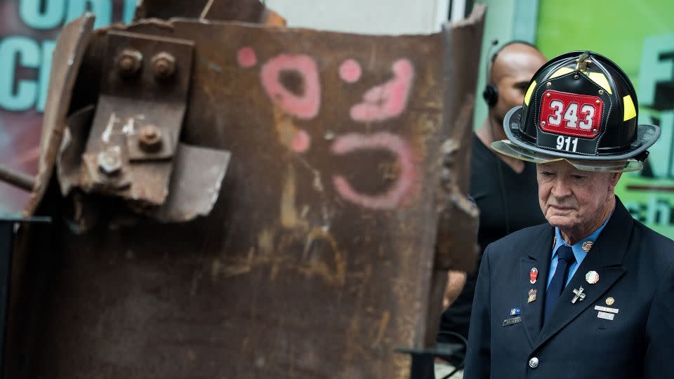 Bob Beckwith stands next to a piece of steel from the World Trade Center during a 2016 ceremony as the memento heads from New York City to Gander, Newfoundland. - Drew Angerer/Getty Images