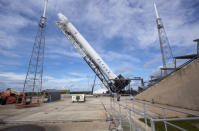 he Space Exploration Technologies Corp., or SpaceX, Falcon 9 rocket with Dragon capsule attached on top is lifted into the vertical position during a rollout demonstration test at Space Launch Complex-40 at Cape Canaveral Air Force Station in F