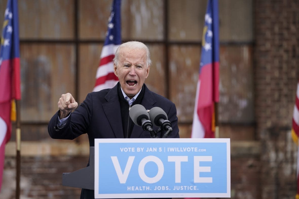 U.S. President-elect Joe Biden speaks during a drive-in rally for U.S. Senate candidates Jon Ossoff and Rev. Raphael Warnock at Pullman Yard on December 15, 2020 in Atlanta, Georgia. Biden’s stop in Georgia comes less than a month before the January 5 runoff election for Ossoff and Warnock as they try to unseat Republican incumbents Sen. David Perdue and Sen. Kelly Loeffler. (Photo by Drew Angerer/Getty Images)