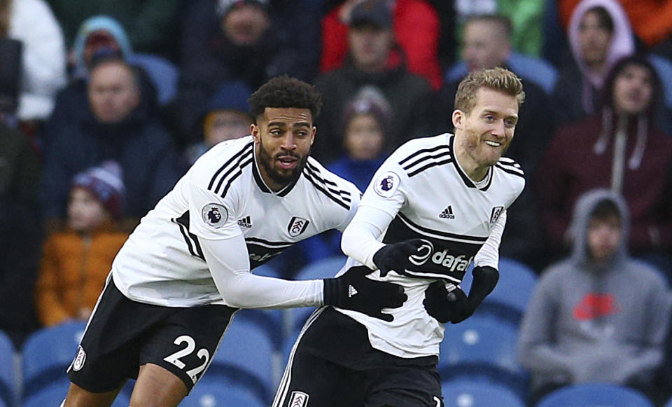 Fulham's Andre Schurrle, right, celebrates scoring his side's first goal of the game during the English Premier League soccer match between Burnley F.C and Fulham at the Turf Moor stadium, Burnley, England. Saturday, Jan. 12, 2019. (Dave Thompson/PA via AP)