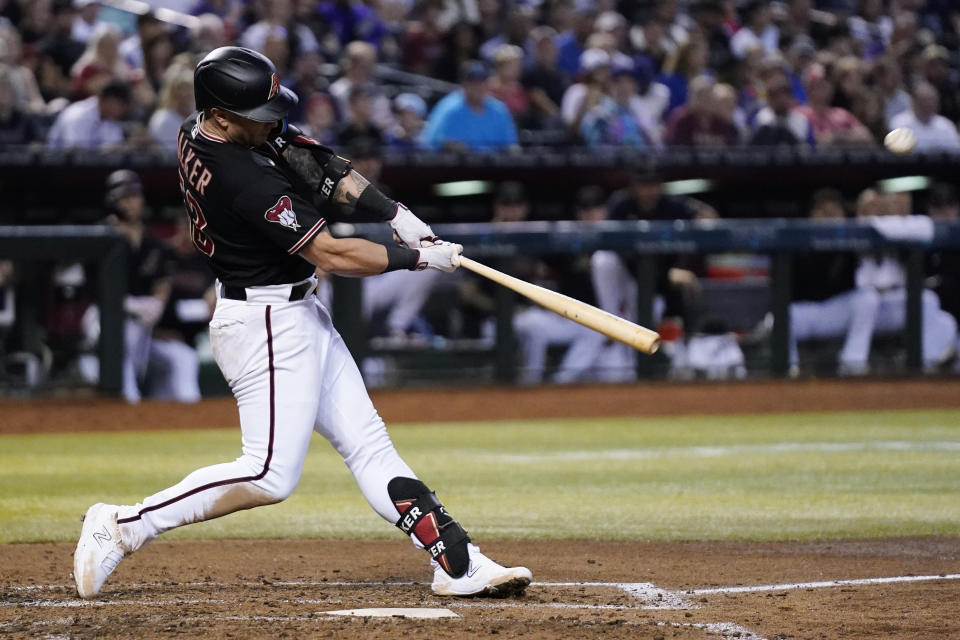 Arizona Diamondbacks' Christian Walker connects for a triple against the Cincinnati Reds during the fifth inning of a baseball game Saturday, Aug. 26, 2023, in Phoenix. (AP Photo/Ross D. Franklin)