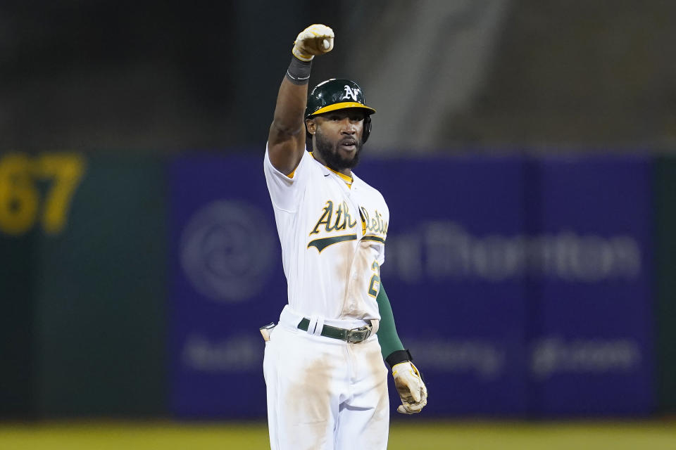 Oakland Athletics' Starling Marte gestures after hitting a two-run double against the Houston Astros during the seventh inning of a baseball game in Oakland, Calif., Friday, Sept. 24, 2021. (AP Photo/Jeff Chiu)