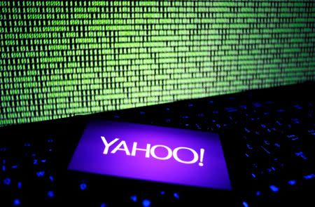 A photo illustration shows a Yahoo logo on a smartphone in front of a displayed cyber code and keyboard on December 15, 2016. REUTERS/Dado Ruvic/Illustration