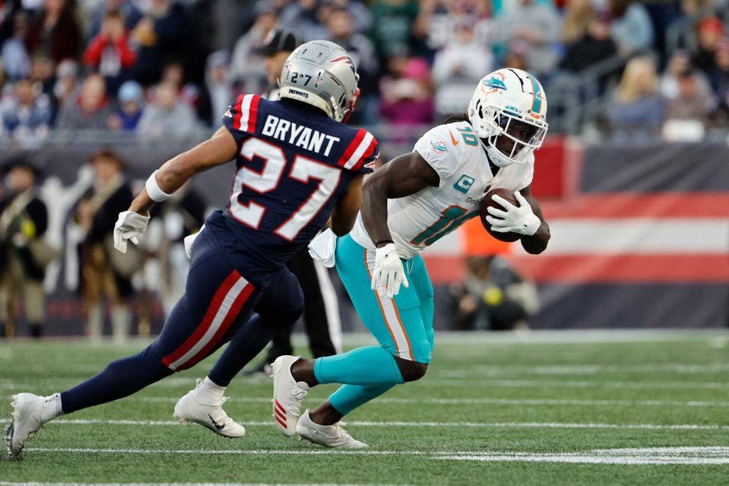  Tyreek Hill #10 of the Miami Dolphins runs against the New England Patriots during the game at Gillette Stadium on January 01, 2023 . 