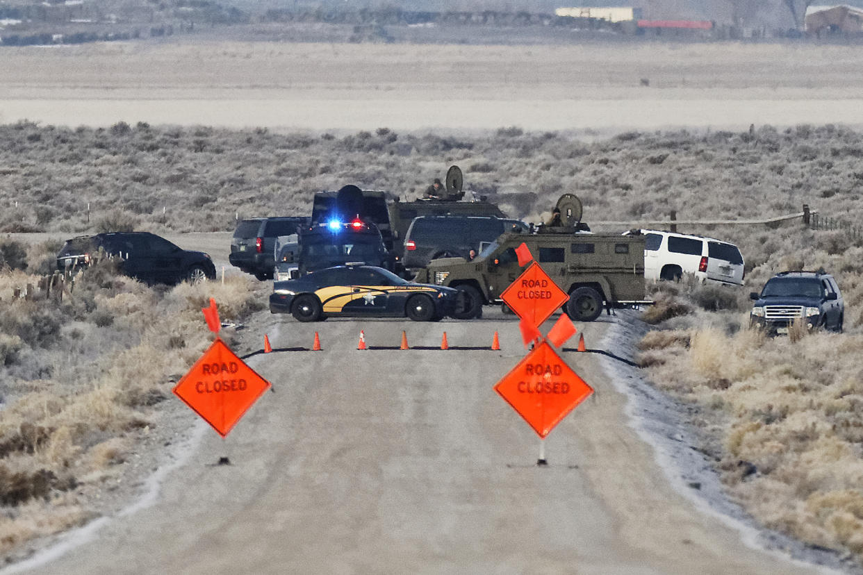 CLICK IMAGE for slideshow: Law enforcement personnel block an access road to the Malheur National Wildlife Refuge near Burns, Ore. (Thomas Boyd/The Oregonian via AP)