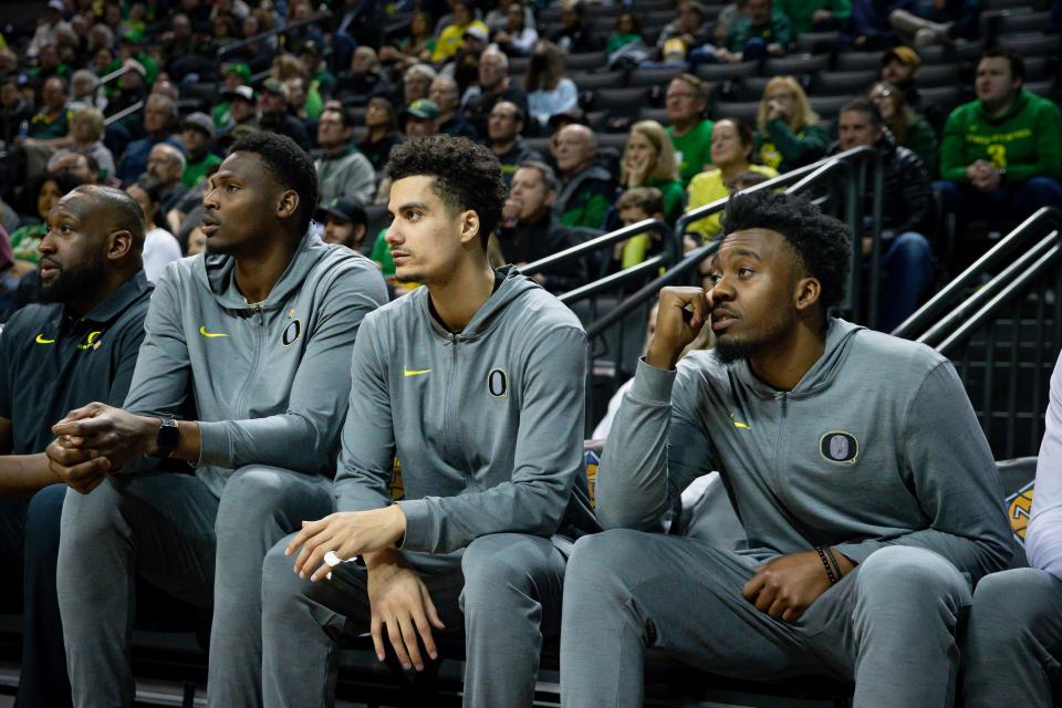 Oregon’s N’Faly Dante, left, Will Richardson and Jermaine Couisnard watch from the bench as the Oregon Ducks take on UC Irvine in their NIT opener Wednesday, March 15, 2023, at Matthew Knight Arena in Eugene, Ore.