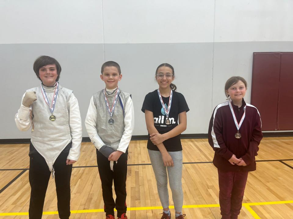 Nahla Green, third from the right, took third place in an Under-14 novice fencing competition in Omaha. Green competes with the Cornerstone Classical School fencing program.
