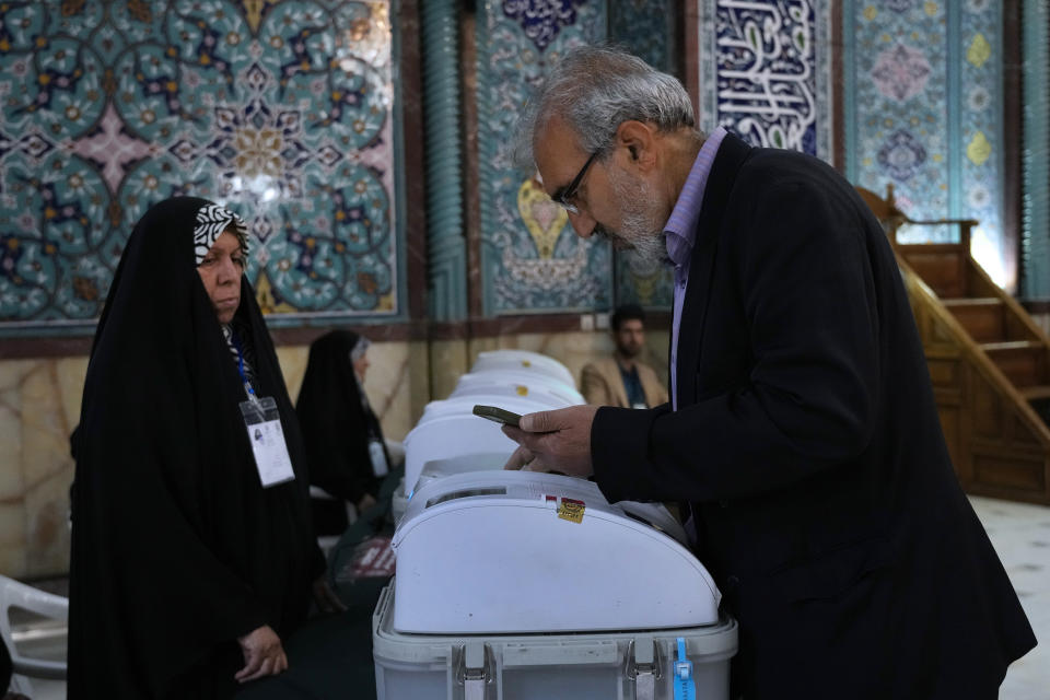 An Iranian man votes for the parliamentary runoff elections at a polling station in Tehran, Iran, Friday, May 10, 2024. Iranians voted Friday in a runoff election for the remaining seats in the country's parliament after hard-line politicians dominated March balloting. (AP Photo/Vahid Salemi)