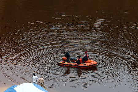 FILE PHOTO: Forensic officers search Kokkinopezoula lake for possible bodies of victims of a suspected serial killer near the village of Mitsero, Cyprus, May 1, 2019. REUTERS/Yiannis Kourtoglou/File Photo