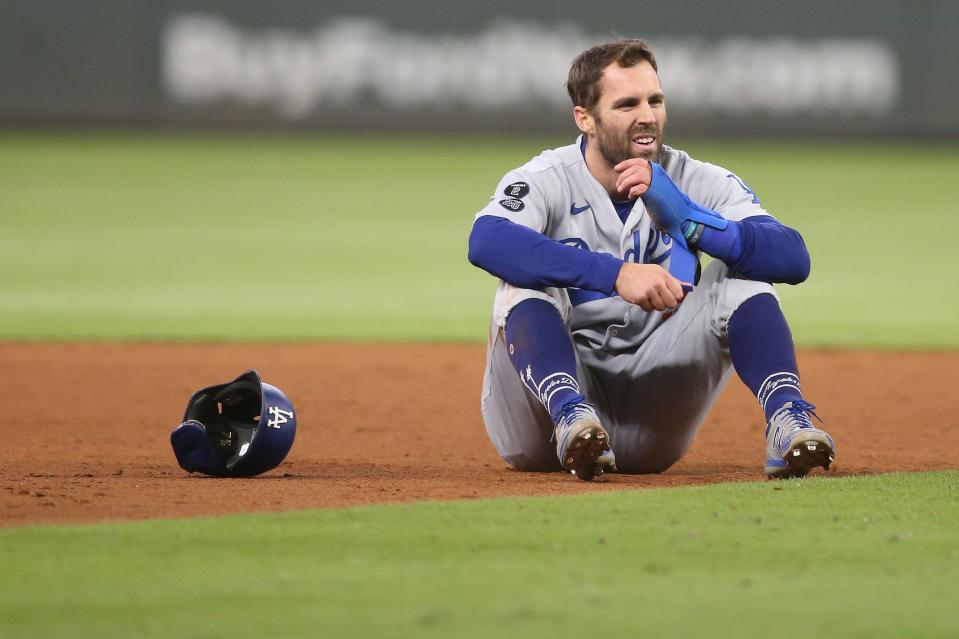 NLCS Game 1: Dodgers left fielder Chris Taylor is tagged out by Braves shortstop Dansby Swanson to end the top of the ninth inning.