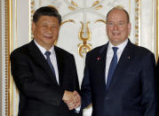 Chinese President Xi Jinping, left, and Prince Albert II of Monaco shake hands as they pose for photographers at Monaco Palace, Sunday, March 24, 2019. Xi is paying the first state visit by a Chinese president to the tiny Mediterranean principality of Monaco on Sunday. (Eric Gaillard/Pool Photo via AP)