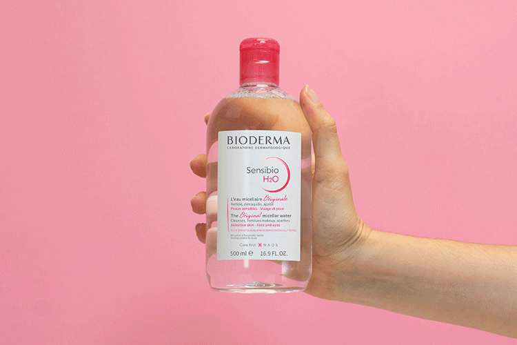 A series of photos of Bioderma micellar water being applied.