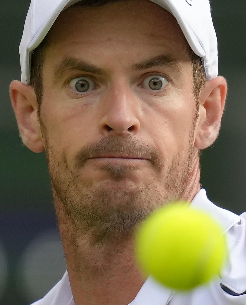 Britain's Andy Murray eyes the ball before playing a return to Australia's James Duckworth in a first round men's singles match on day one of the Wimbledon tennis championships in London, Monday, June 27, 2022. (AP Photo/Kirsty Wigglesworth)