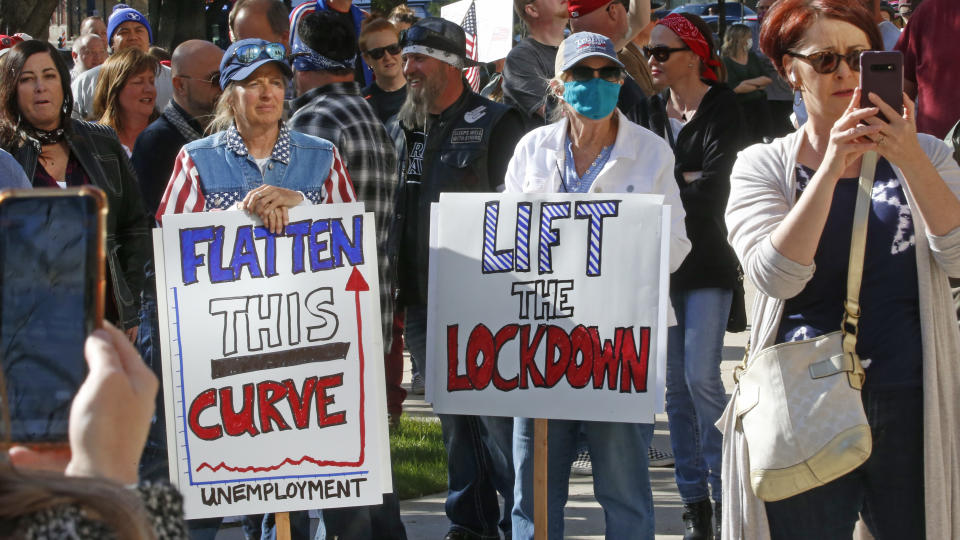 FILE - In this April 18, 2020, file photo, people gather during the Utah Business Revival rally, calling for Utah's economy to be re-opened, in Salt Lake City .Utah is seeing a spike in new COVID-19 cases about a month after many businesses were allowed to reopen, leading state health officials to issue renewed pleas for people to maintain social distancing. (AP Photo/Rick Bowmer, File)