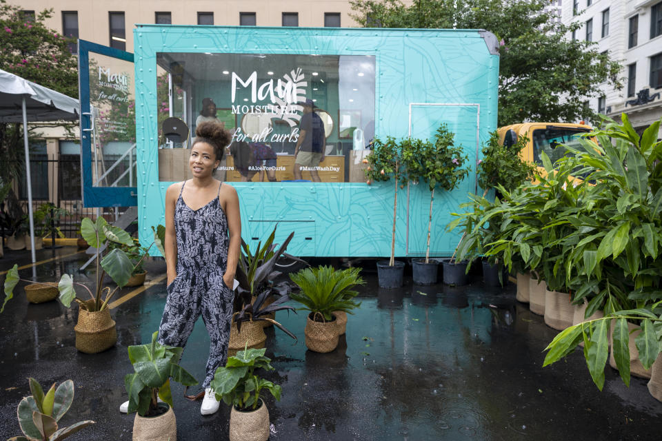 Vanessa Dawson, back left, producer of Maui Moisture, stands in her hair care truck near the Essence Festival in downtown New Orleans on Thursday, June 30, 2022. Essence's chief executive officer said she's been asked a multitude of times whether the Essence Festival of Culture is staying in New Orleans. On Thursday, Caroline Wanga ended any speculation, making the answer to that question very clear.(Chris Granger/The Times-Picayune/The New Orleans Advocate via AP)