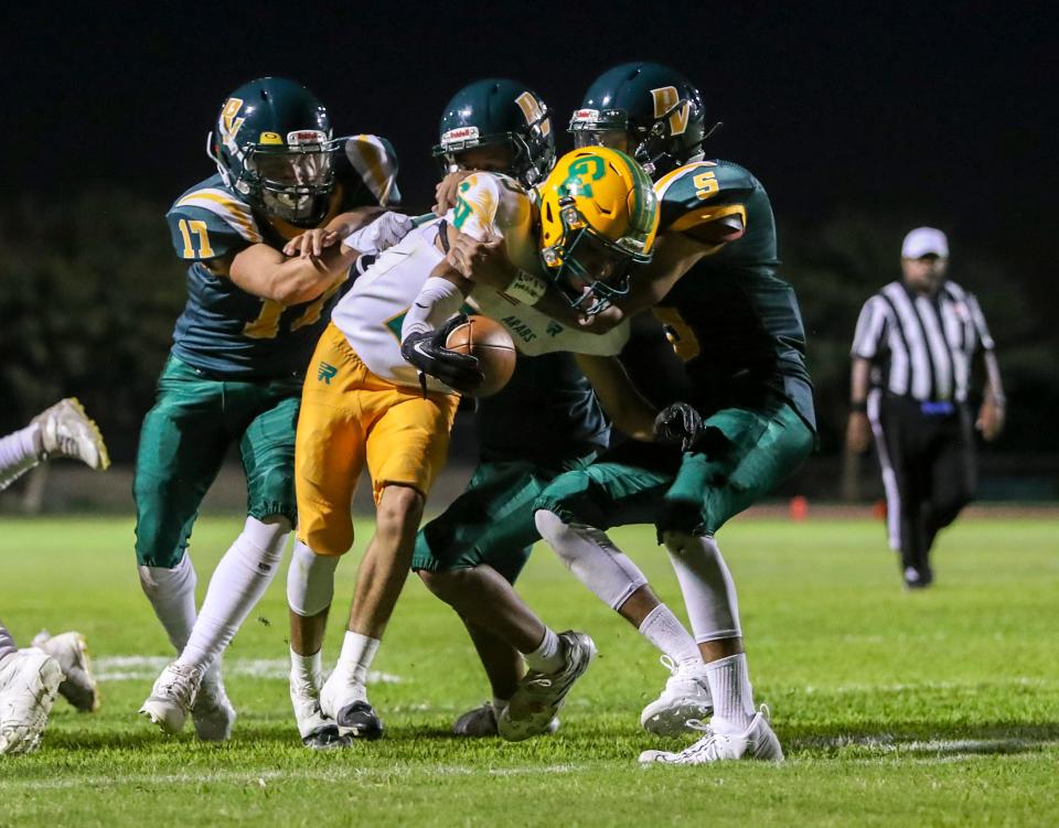 Coachella Valley's Aaron Ramirez (23) runs through three defenders for a touchdown during the second quarter of their game at Palo Verde High School in Blythe, Calif., Friday, Aug. 25, 2023.