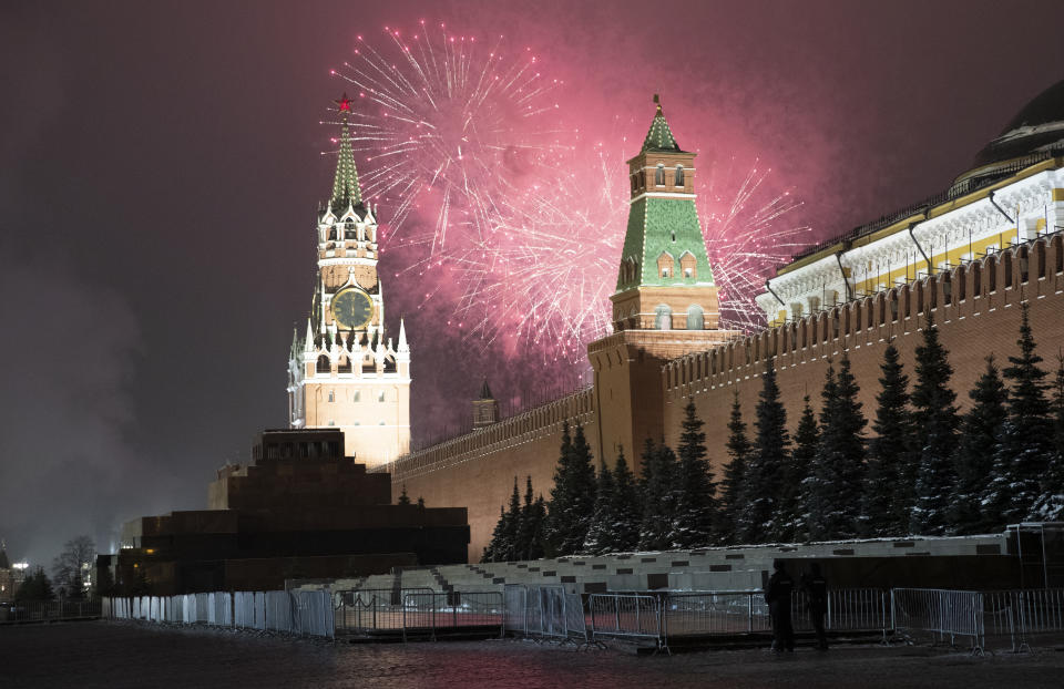Fireworks explode over the Kremlin and almost empty Red Square during New Year's celebrations with the Spasskaya Tower during New Year celebrations, in Moscow, Russia, Thursday, Dec. 31, 2020. (AP Photo/Pavel Golovkin)