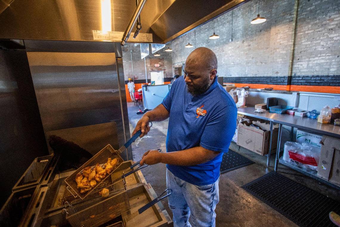 Thomas Williams, the owner of Wing KYng, works to make wings in the kitchen of his storefront at Greyline Station in Lexington, Ky., Thursday, May 11, 2023. Silas Walker/swalker@herald-leader.com