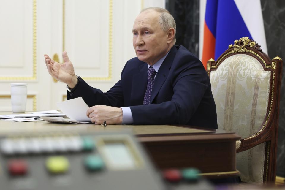 Russian President Vladimir Putin gestures while speaking at a meeting of the Presidential Council for Science and Education via videoconference at the Kremlin in Moscow, Russia, Thursday, Feb. 8, 2024. (Alexander Kazakov, Sputnik, Kremlin Pool Photo via AP)