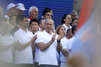 Former Armenian President Robert Kocharyan applauds during a rally of his supporters in Yerevan, Armenia, Friday, June 18, 2021. In Sunday's election, more than 2,000 polling stations will open across Armenia, with nearly 2.6 million people eligible to vote. The ballot includes 21 political parties and four electoral blocs, but two political forces are seen as the main contenders: the ruling Civic Contract party led by Pashinyan and the Armenia alliance, led by former President Robert Kocharyan. (AP Photo/Sergei Grits)