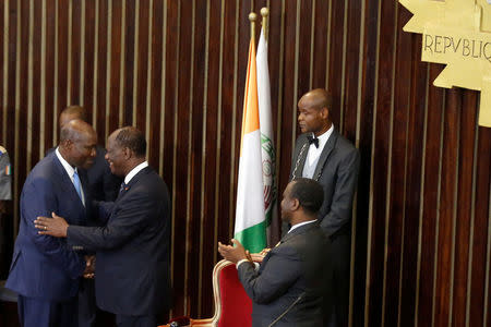 Ivory Coast's President Alassane Ouattara (C) congratulates former prime minister Daniel Kablan Duncan as he appoints him vice-president inside the Ivorian parliament in Abidjan, Ivory Coast January 10, 2017. REUTERS/Thierry Gouegnon